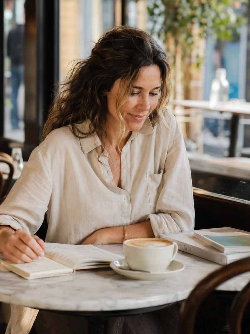 Claire Hartley — wellness writer and author of The 21-Day Gut Reset, photographed at a café in Melbourne